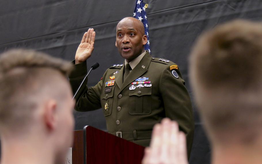 Lt. Gen. Xavier Brunson presents the oath of enlistment to 18 high school military recruits during a ceremony at Saint Martin University, Lacey, Wash., on May 3, 2022. 