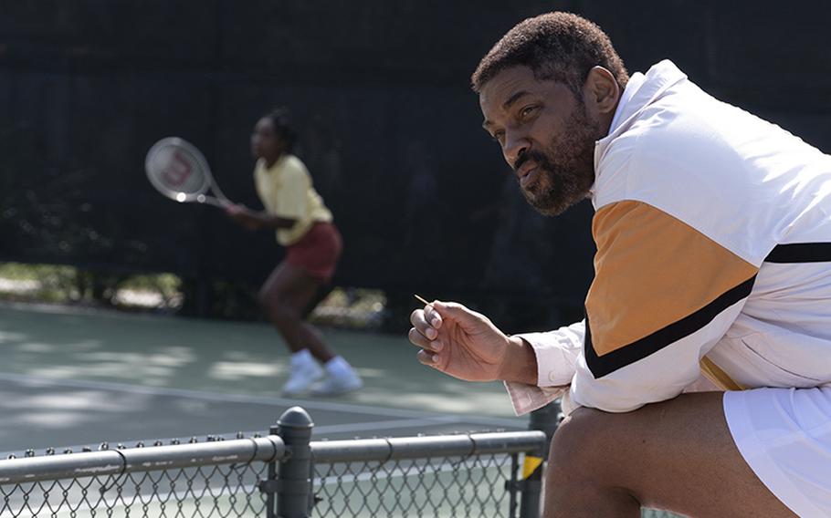 Richard Williams (Will Smith) watches on as Venus (Saniyya Sidney) plays tennis in “King Richard,” now playing at select theaters on base.