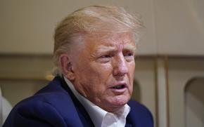 Former President Donald Trump speaks with reporters while in flight on his plane after a campaign rally at Waco Regional Airport, in Waco, Texas, Saturday, March 25, 2023, while en route to West Palm Beach, Fla. (AP Photo/Evan Vucci)
