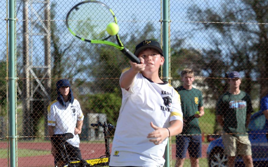 Kadena's Maddux Fisk hits a forehand return to Kubasaki's Owen Ruksc during Tuesday's Okinawa tennis matches. Ruksc won 6-0 and the Dragons boys beat the Panthers 4-2.