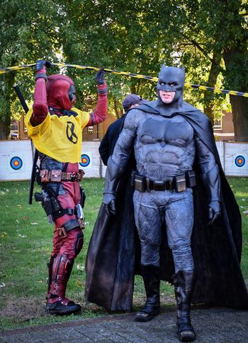Cosplayers of comic book characters Batman and Deadpool greet Mil-D-Con attendees Oct. 1, 2022, at RAF Mildenhall, England.