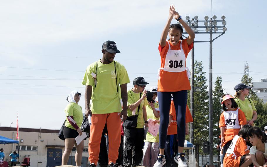 Daisy Elliott, of Yokota High School, competes in the standing long jump during the Kanto Plains Special Olympics at Yokota Air Base, Japan, Saturday, Nov. 4, 2022.