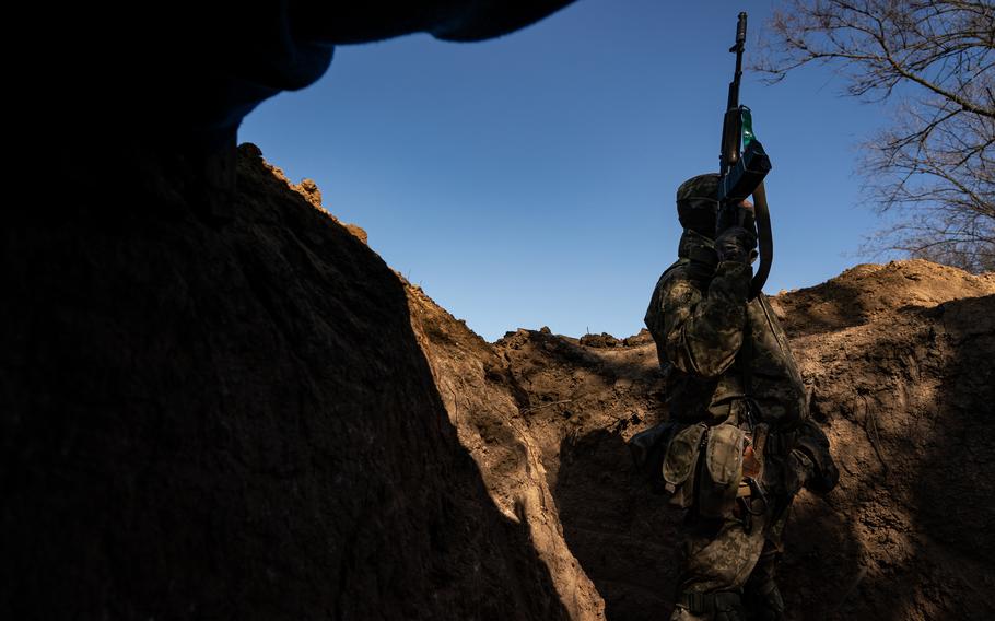 A Ukrainian sergeant walks through trenches on the front lines between Mykolaiv and Kherson in Ukraine on March 22. 