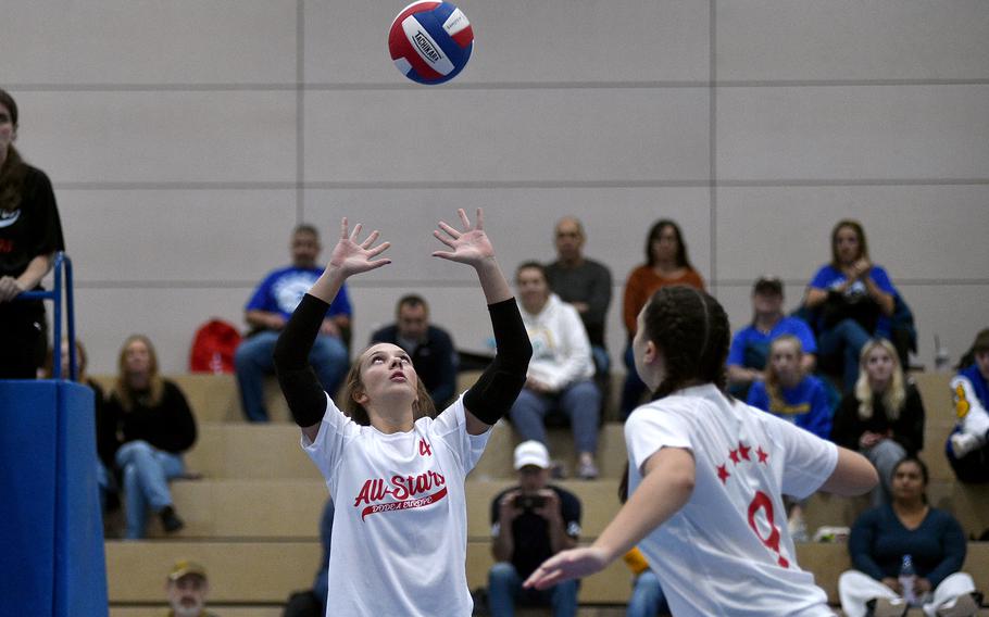 White Team's Berea Bryan of Stuttgart sets the ball while teammate Kennedy Lange of Ansbach rushes the net during a DODEA-Europe all-star volleyball match on Nov. 4, 2023, at Ramstein High School on Ramstein Air Base, Germany.