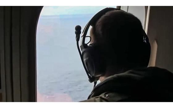 A video screen grab shows a crewmember aboard a U.S. Navy P-8A Poseidon patrol aircraft in April 2014, while the aircraft was flying a search mission over the Indian Ocean in support of the international effort to locate Malaysia Airlines Flight MH370. 
