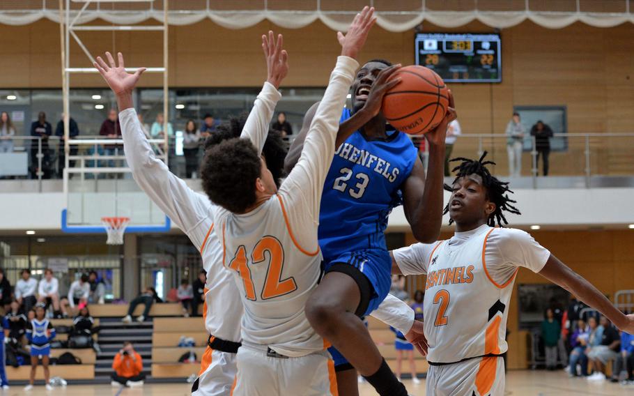 Hohenfels’ Jacob Idowu goes to the basket against Spangdahlem’s Jeremy White in the boys Division III final at the DODEA-Europe basketball championships in Wiesbaden, Germany, Feb. 17, 2024. Spangdahlem beat Hohenfels 65-63 to take the title.
