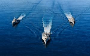 Three U.S. Navy littoral combat ships sail in formation in the eastern Pacific in 2019. The Navy's current shipbuilding practices led to large cost overruns in building the ships, according to a government watchdog agency.