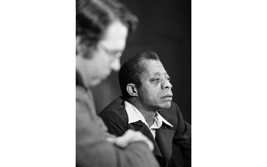 Author James Baldwin listens to a question from the audience.