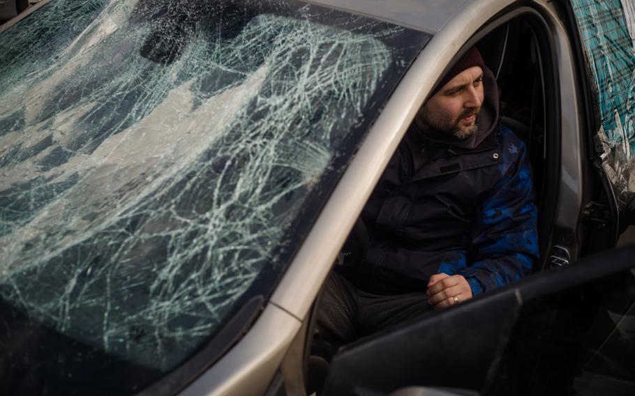 A man shows up to the registration center in Zaporizhzhia, Ukraine, with his car windshield smashed by a rocket blast.
