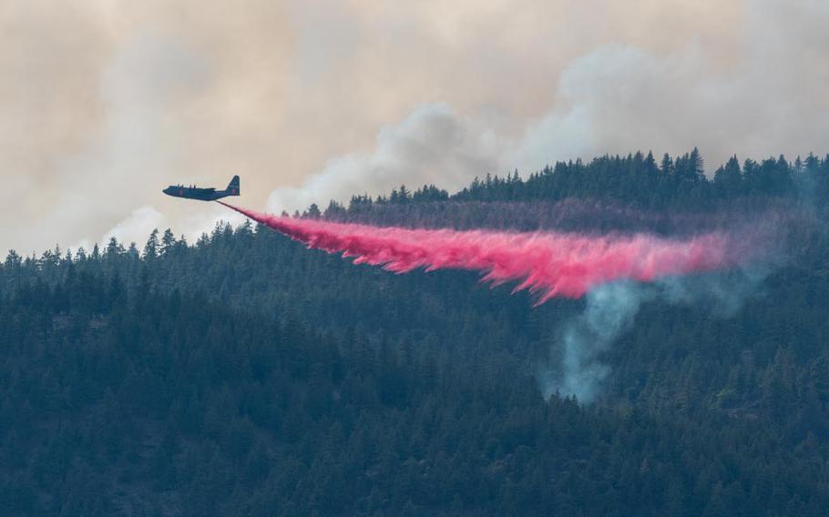 An Air National Guard C-130 out of Reno, Nev., drops fire retardant on the Beckwourth Complex Fire on July 9, 2021 near Frenchman Lake in Northern California. Military aircraft are generally asked to join firefighting efforts when all commercial air tankers are already at work or unavailable. This was one of the busiest years for military firefighting aircraft on record. 