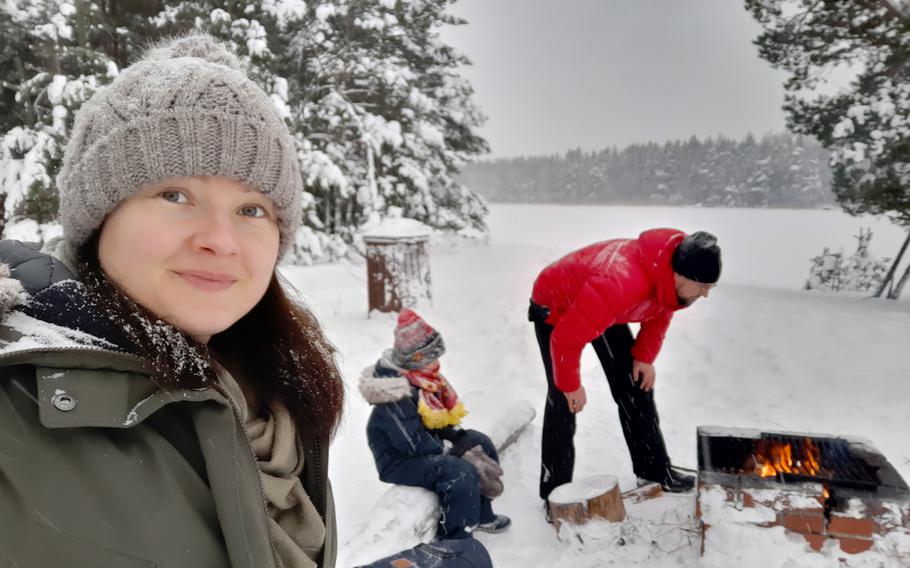 Veera Lavikkala cooks hot dogs in the snow with her family. 