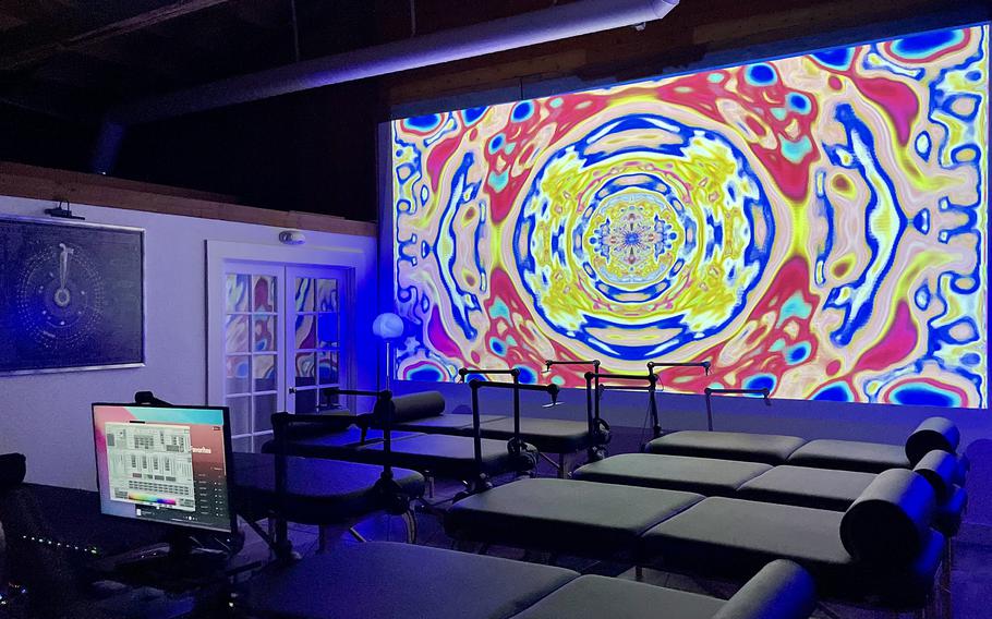 The main room at the Reality Center in Santa Monica, with its massage tables, video screen and audio and visual equipment, has a fitness-studio-meets-high-tech-rave vibe. 
