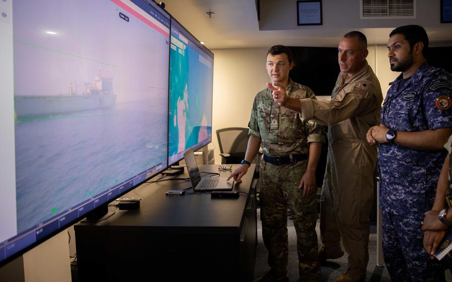 Personnel from U.S. 5th Fleet and Combined Task Force 152 monitor visuals transmitted from an unmanned surface vessel Oct. 26, 2022. During the exercise, the drones operated in conjunction with crewed ships from four navies.