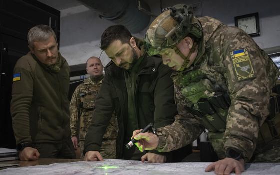 FILE - Ukrainian President Volodymyr Zelenskyy, Commander of Ukraine's Ground Forces Col.-Gen. Oleksandr Syrski, right, look at a map during their visit to the front line city of Kupiansk, Kharkiv region, Ukraine, on Nov. 30, 2023. Ukraine’s commander in chief, Oleksandr Syrski, said Russia’s top military leadership ordered its soldiers to capture the town of Chasiv Yar by May 9, Russia’s Victory Day, a holiday that marks the defeat of Nazi Germany. (AP Photo/Efrem Lukatsky, File)
