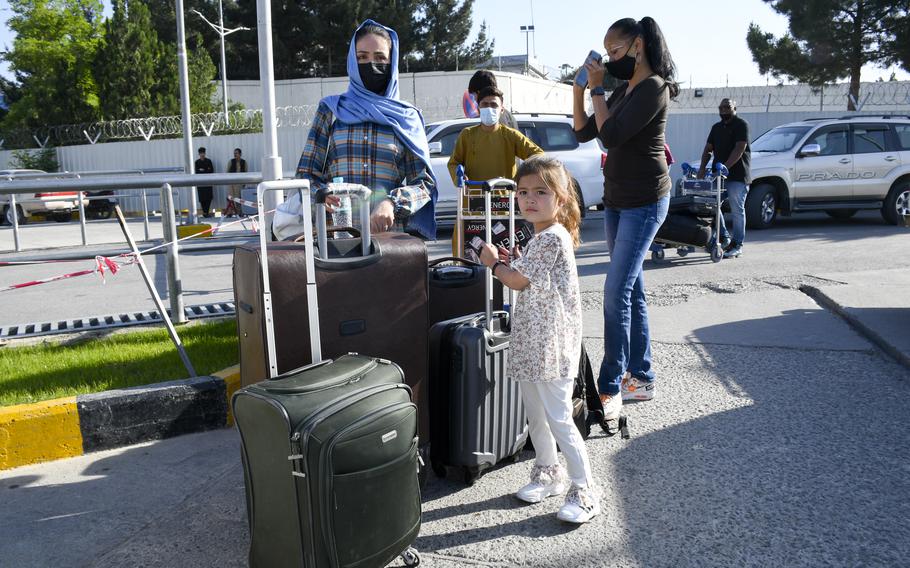 Rahima Asadi, left, her daughter Zainab, and the family’s lawyer, Kimberley Motley, stand by their luggage prior to leaving Afghanistan on June 1, 2021. For six months, the Asadis hid on the outskirts of Kabul due to fears of assassination by the Taliban and retribution from the Afghan government for wanting to leave the country. 