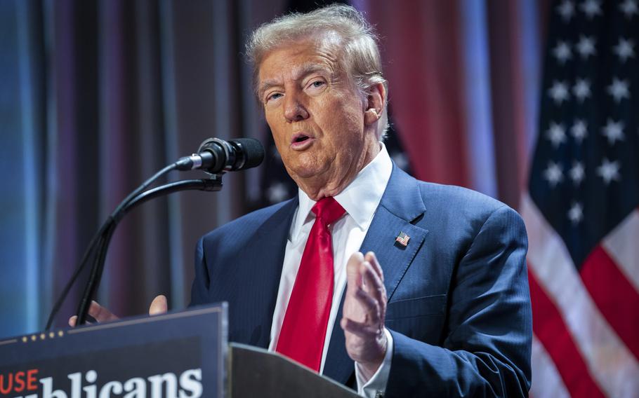 Donald Trump at the microphone during a meeting with the House GOP conference.