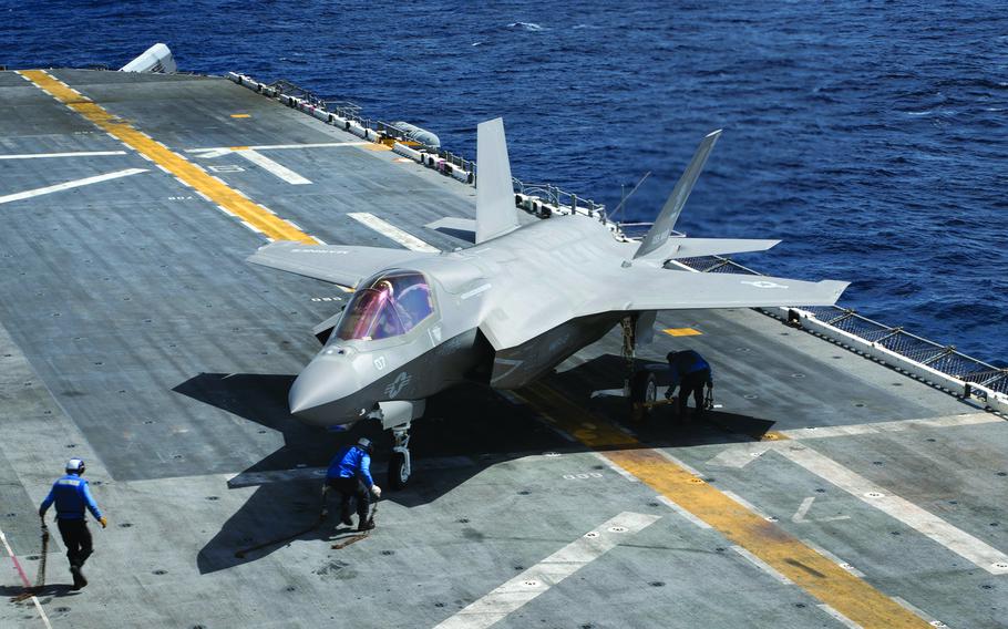 Sailors aboard the USS Wasp tie down an F-35B Lightning II stealth fighter, March 23, 2018.