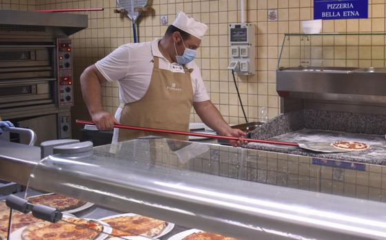 A food service worker prepares pizza at Ristorante Bella Etna at Naval Air Station Sigonella, Italy, July 31, 2020. Earlier this month, Bella Etna was named best overseas galley for 2025, marking the seventh time it has won the Capt. Edward F. Ney Memorial Award, the Navy’s highest honor for food service.

