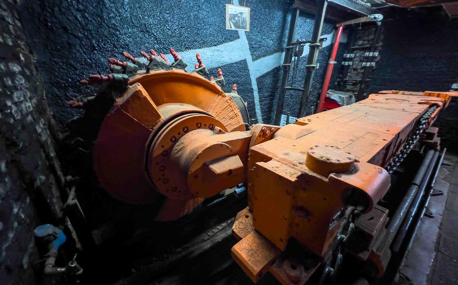 A decommissioned coal drilling machine in the underground corridor at the Saarland Mining Museum in Bexbach, Germany. The museum displays the tools that shaped Saarland's industrial past. 