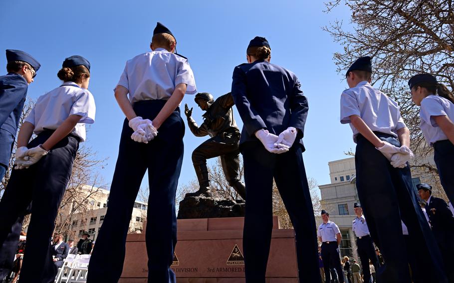 Cadets with the Colorado Civil Air Patrol stand before the newly erected Major General Maurice Rose Monument in Lincoln Veterans Memorial Park on April 16, 2023, in Denver.