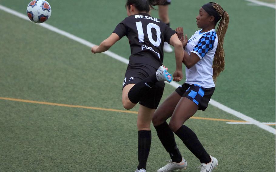 Seoul Foreign's Stephanie Woo boots the ball away from Osan's Tatiana Lunn during Wednesday's Korea girls socceer match. The Crusaders won 5-1.