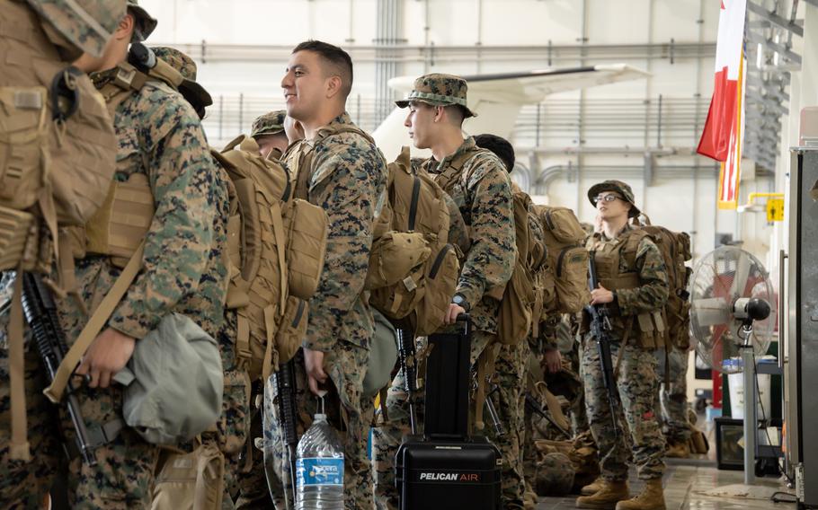 U.S. Marines and Sailors with 3rd Marine Logistics Group wait to weigh in with their gear during a drill at Kadena Air Base, Okinawa, Japan, Jan. 11, 2023. The Marines conducted the exercise to prepare to react quickly to a crisis, counter potential threats, and assist allies and partners throughout the Indo-Pacific region in maintaining regional stability.