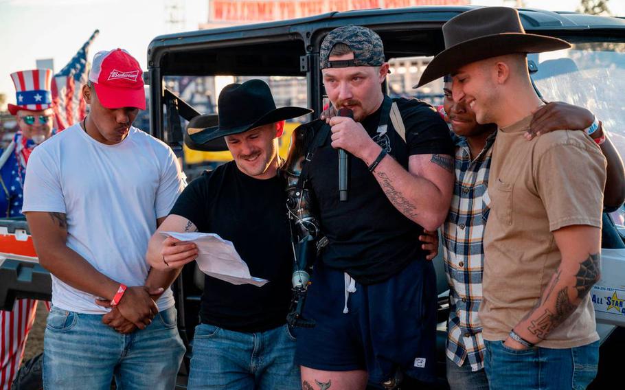 U.S. Marine Sgt. Tyler Vargas-Andrew, center, is joined by some of his Marine Corps brothers in arms, Christian Ritter, Daulton Hannigan, Caden Cooper and Jorge Mayo, as he addresses the crowd at the Folsom Pro Rodeo on Sunday, july 3, 2022. Hannigan, Cooper and Mayo served in his unit in Kabul. The ceremony honored the 13 U.S. service members killed and 18 Marines that were seriously wounded at the Kabul airport bombing in Afghanistan, including Vargas-Andrews.