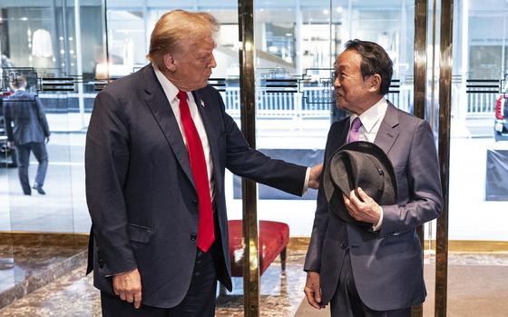 Donald Trump greets former Japanese Prime Minister Taro Aso at Trump Tower in New York on April 23, 2024.