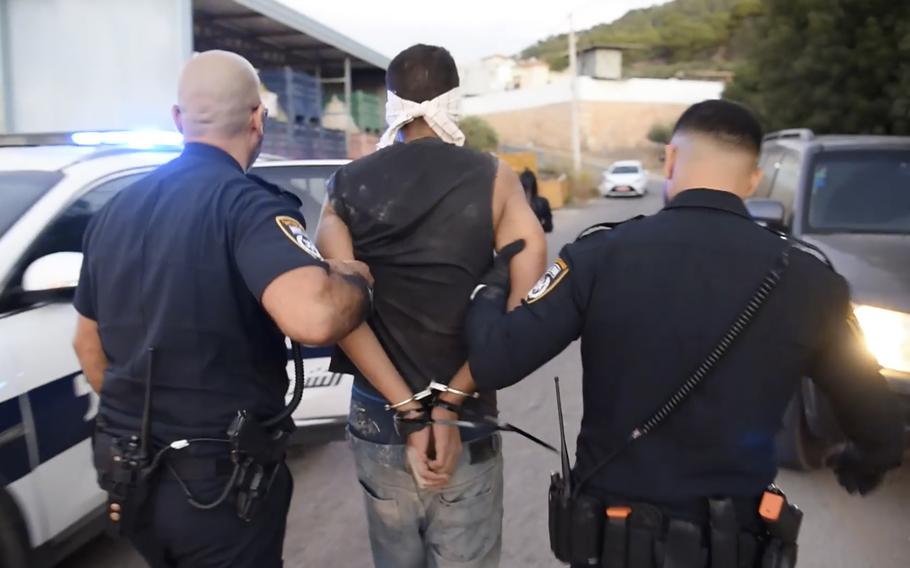 Palestinian fugitive Zakaria Zubeidi is arrested by Israeli police officers, in Umm al Ghanam, northern Israel, Saturday, Sept. 11, 2021.