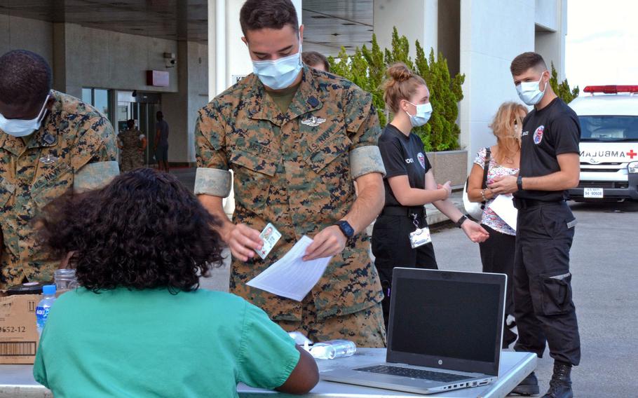 Service members line up to receive the influenza vaccine at U.S. Naval Hospital Okinawa on Camp Foster, Friday, Oct. 1, 2021.