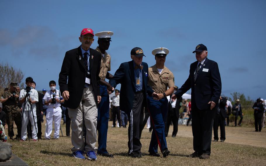 A Marine escorts Battle of Iwo Jima veterans during the Reunion of Honor ceremony March 25, 2023, at Iwo Jima, Japan.