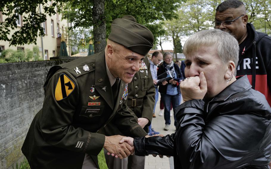 Marina Hilbert receives a challenge coin from U.S. Army Col. Deon Maxwell in Pirmasens, Germany, on Wednesday, May 8, 2024, in recognition of her efforts to connect veterans through her Facebook group. Maxwell is the commander of U.S. Army Medical Materiel Center-Europe, which once operated a depot in Pirmasens.