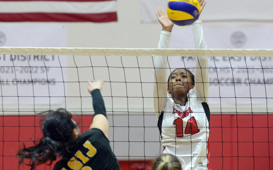 Nile C. Kinnick's Tristyn Hatcher goes up to block a shot by American School In Japan's Sachika Nagaoka during Tuesday's Kanto Plain volleyball match. The Red Devils won in five sets.