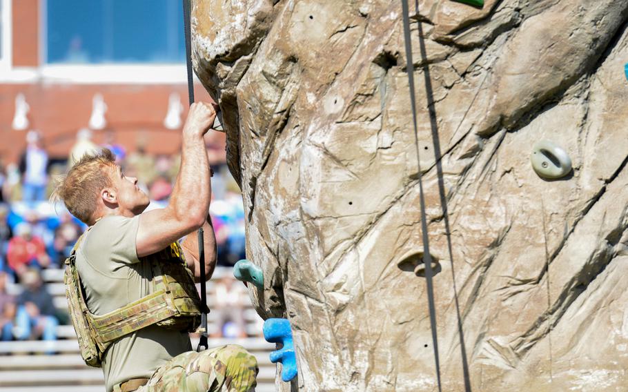A Best Ranger competitor climbs a rock wall obstacle during the second day of the Army’s annual Best Ranger Competition on Saturday, April 13, 2024, at A.J. McClung Stadium in downtown Columbus, Ga. 