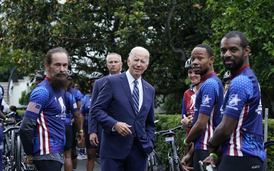 President Joe Biden talks to riders at the White House in Washington, Thursday, June 23, 2022, during an event to welcome wounded warriors, their caregivers and families to the White House as part of the annual Soldier Ride to recognize the service, sacrifice, and recovery journey for wounded, ill, and injured service members and veterans. 