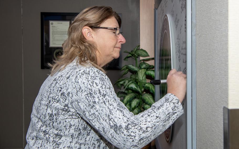 Laura DeSimone, the executive director of the Missile Defense Agency, signs a board Nov. 29, 2023, at Schriever Space Force Base, Colo.