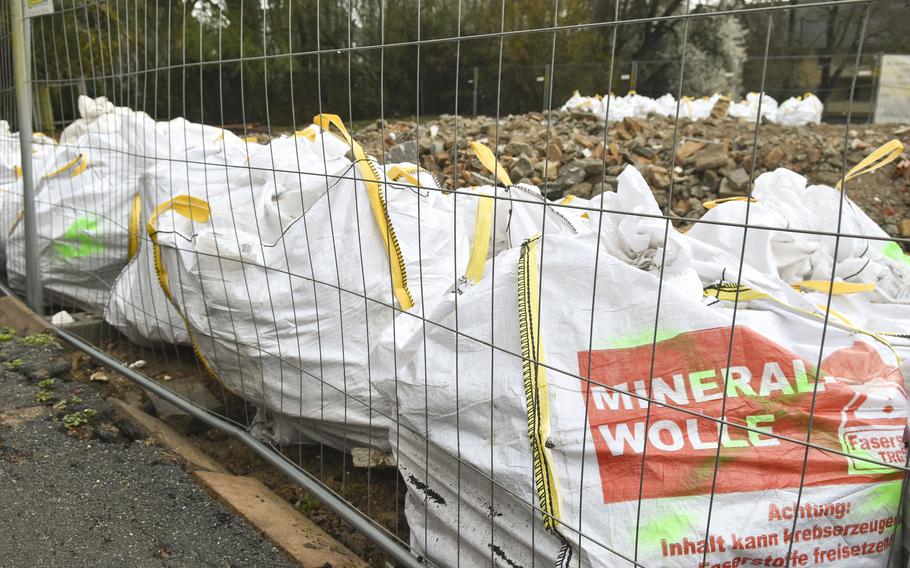 Construction waste bags line the perimeter of a building demolition area in the Army's Crestview neighborhood in Wiesbaden, Germany, on March 11, 2024.