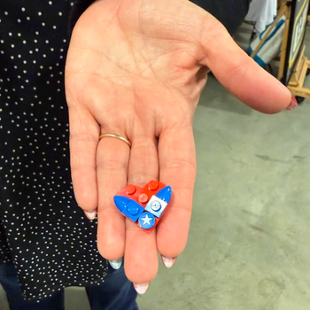 A LEGO piece that looks like the Air Force logo shaped in a heart.