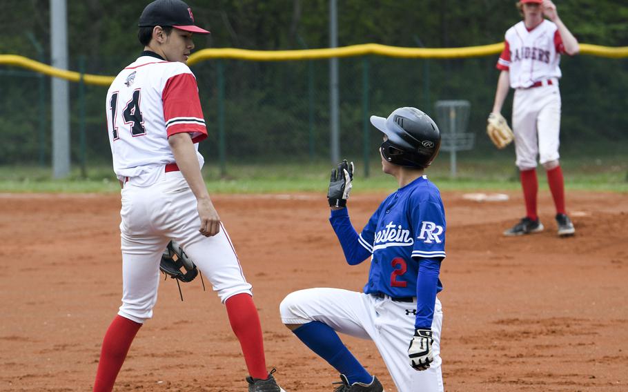 Ramstein's Donovan Kaya waves to Kaiserslautern third baseman after narrowly escaping a tag during a game Saturday, April 30, 2022.
