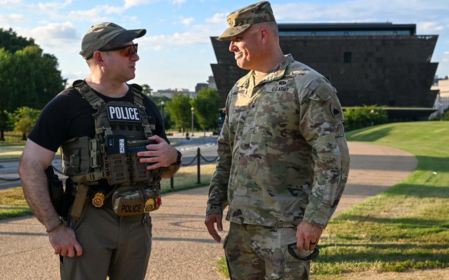 Blanchard and a DEA agent stand on the mall with the Smithsonian Museum of African American History in the background.