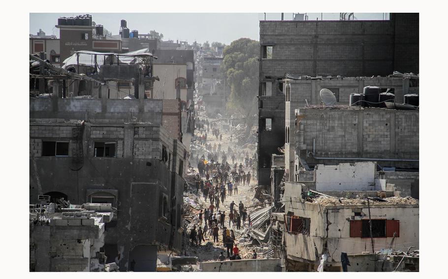 Palestinians make their way as they inspect the damages after Israeli forces withdrew from a part of Jabalia refugee camp, following a raid, in the northern Gaza Strip, on May 30, 2024. 
