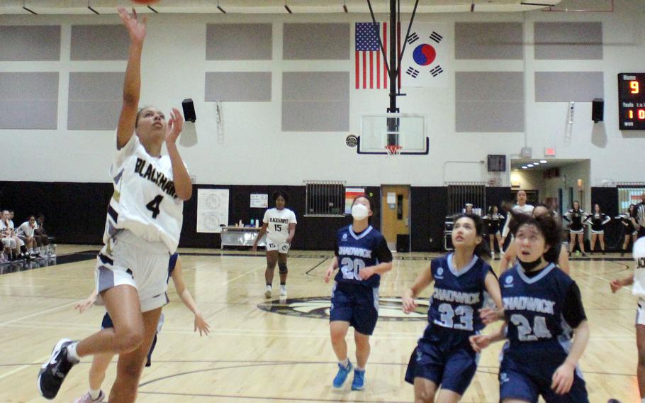 Humphreys' Nicole Donaldson drives ahead of Chadwick's defense during Wednesday's Korea girls basketball game. The Blackhawks won 55-9.