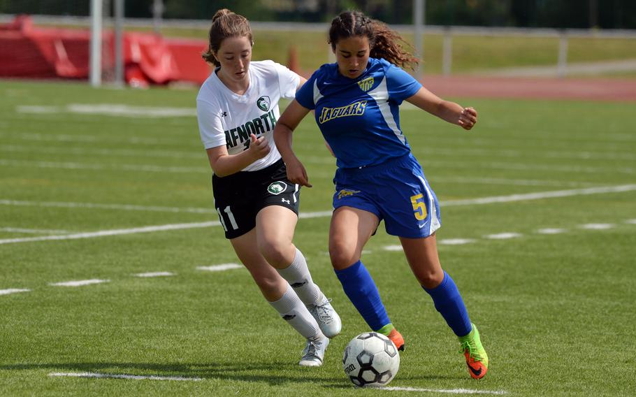 Sigonella’s Charlize Caro takes the ball upfield against AFNORT’s Sheckinah Boswell n the girls Division III final at the DODEA-Europe soccer championships in Kaiserslautern, Germany, Thursday, May 19, 2022. The Jaguars beat the Lions 3-1 to take the Division III title.