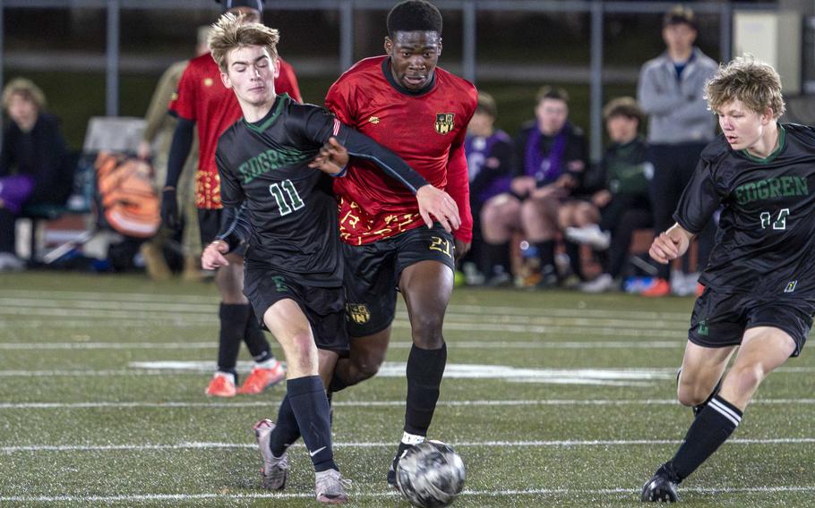 Koboyo Awesso and Luke Lehner battle for the ball.