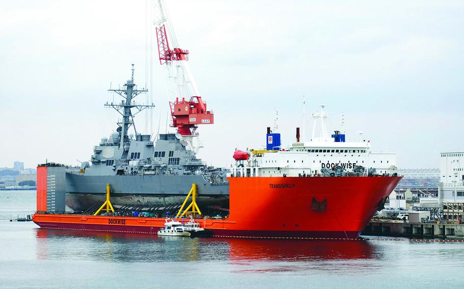 The collision-damaged USS Fitzgerald is pictured aboard the MV Transshelf at Yokosuka Naval Base, Japan, Nov. 27, 2017.