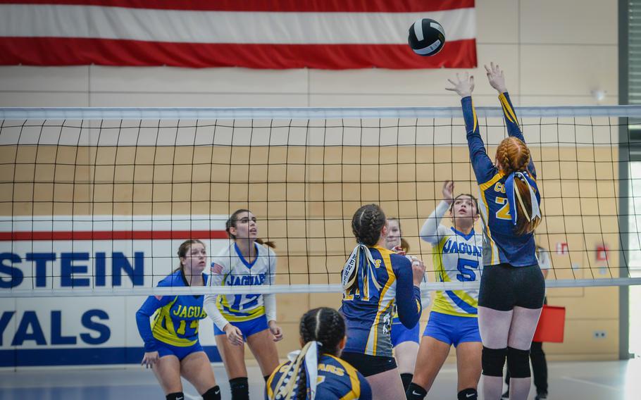 Ansbach’s Tierney Bogard hits the ball across the net as Ryleigh Denton of Sigonella jumps for the block during the 2022 DODEA-Europe Volleyball Tournament Division III championship game Oct. 29, 2022, at Ramstein Air Base, Germany. 