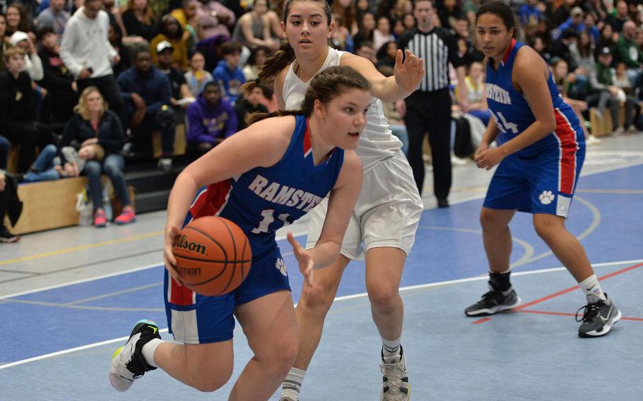 Ramstein’s Katya von Eicken drives along the baseline past Wiesbaden’s Natalia Bergdorf in the Division I championship game at the DODEA-Europe basketball championships in Ramstein, Germany, Feb. 18, 2023. The Warriors beat the Royals 43-34 to take the title.