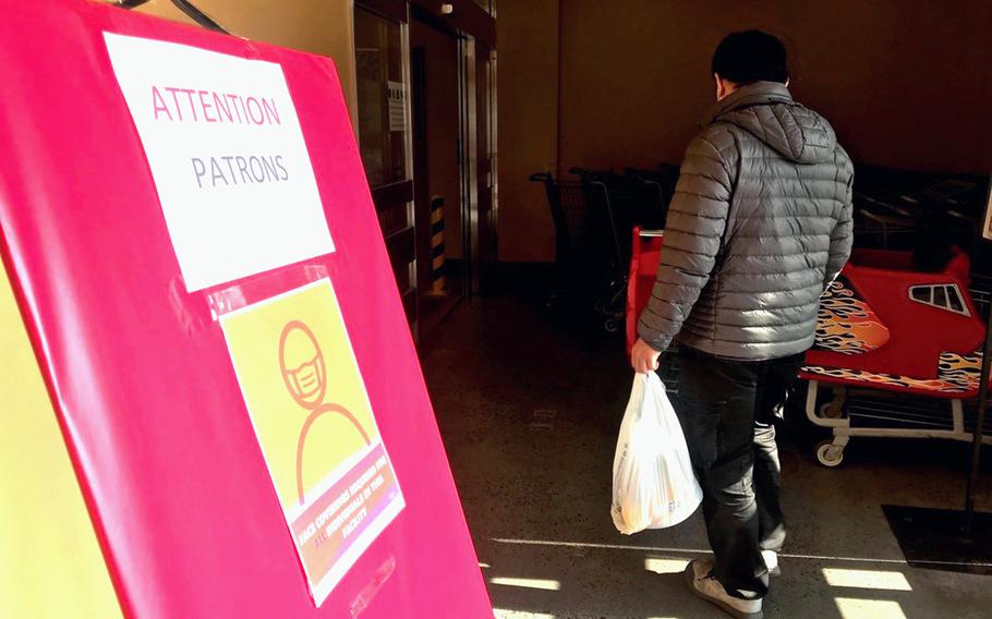 A sign outside the commissary at Marine Corps Air Station Iwakuni, Japan, reminds patrons to wear a mask inside to reduce the spread of COVID-19, Tuesday, Jan. 4, 2022.