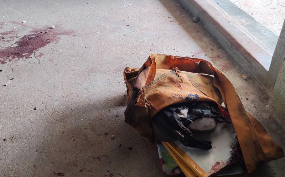 A school bag lies next to dried blood stains on the floor of a middle school in Let Yet Kone village in Tabayin township in the Sagaing region of Myanmar on Sept. 17, 2022, the day after an air strike hit the school.