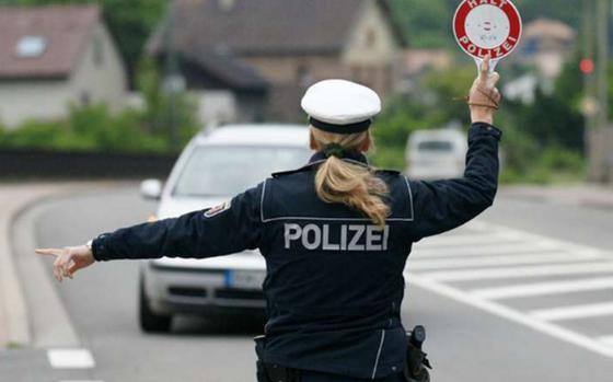 A German police officer directs traffic.